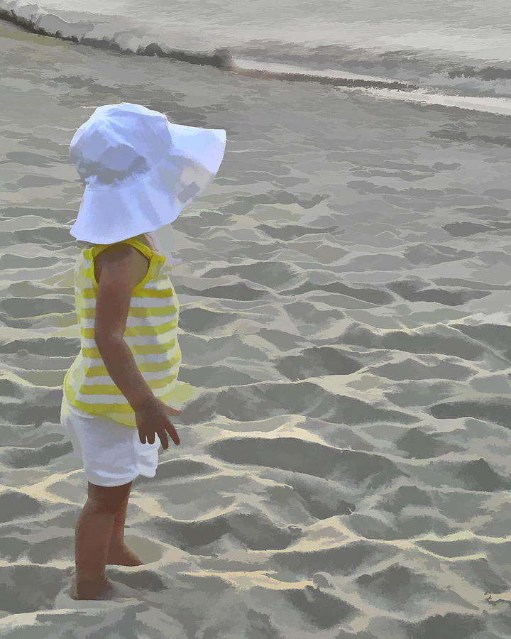 Young girl on beach with hat. Photograph by Jack Nevitt