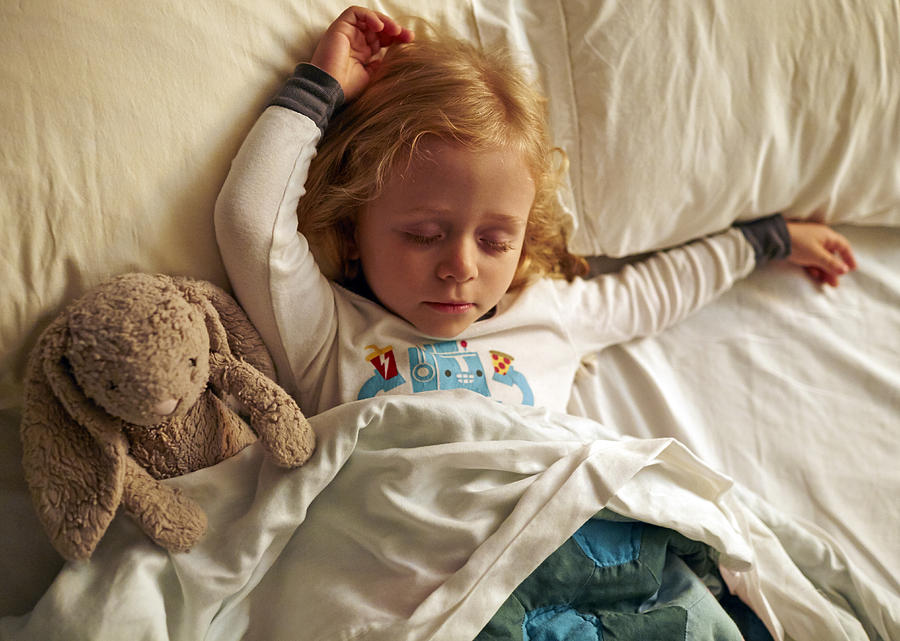Young girl sleepign with stuffed rabbit Photograph by Matt Carr