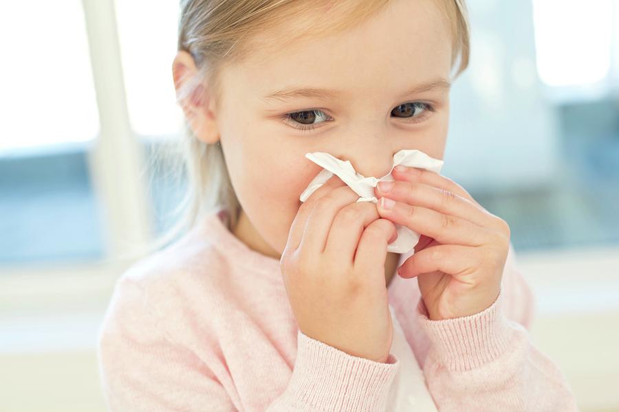 Young Girl Wiping Nose On Tissue Photograph by Science Photo Library ...