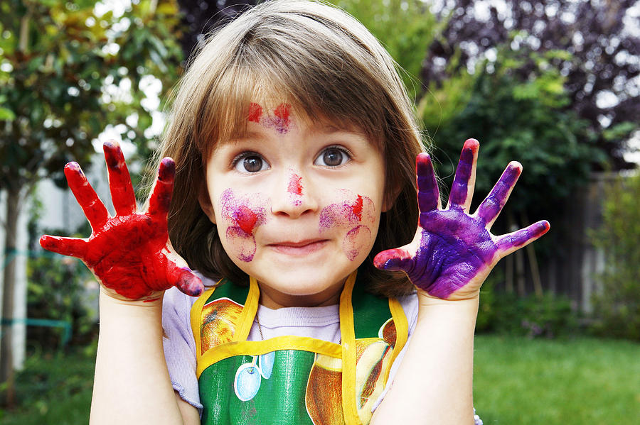 Young girl with painted hands and face Photograph by Geri Lavrov