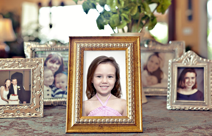 Young girls picture in a frame with others behind Photograph by Caroline Purser