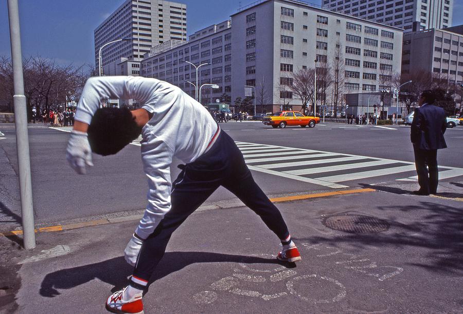 Young Japanese man practices yoga on the sidewalk Tokyo Photograph by Blair Seitz