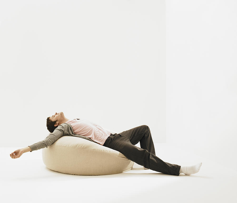 Young man laying on beanbag. Photograph by Dougal Waters