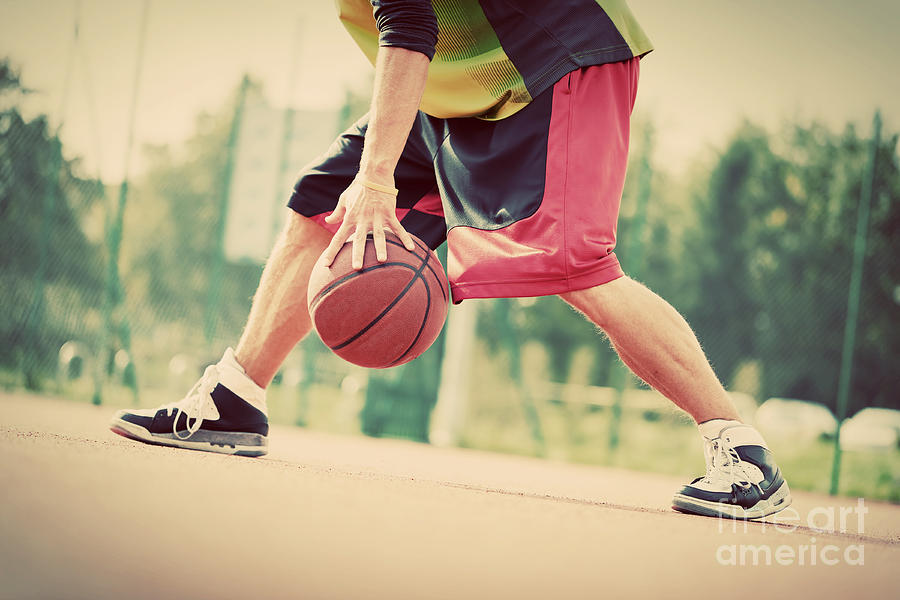 Young Man On Basketball Court Dribbling With Ball Photograph