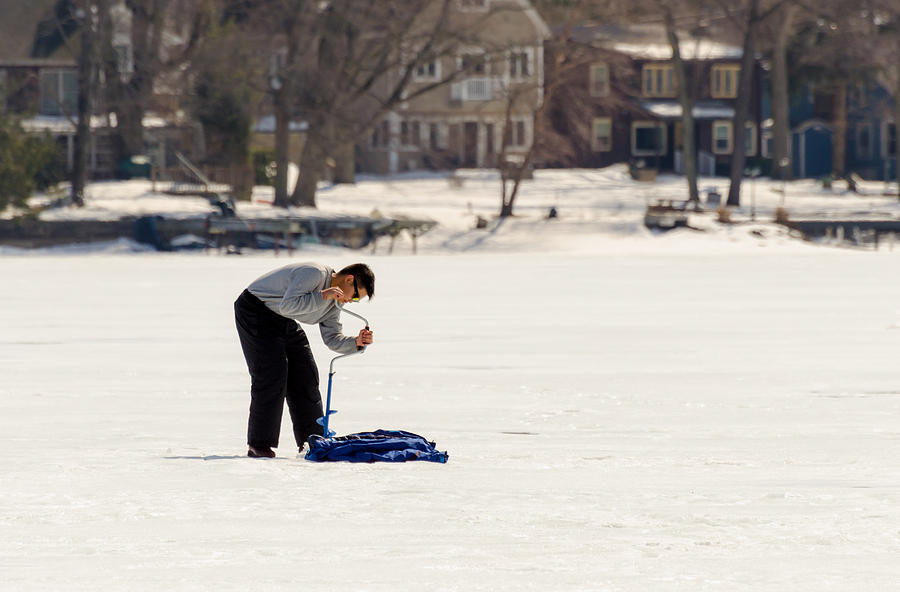Young Man Opening Up The Ice on Lake Hopatcong Photograph by Maureen E Ritter