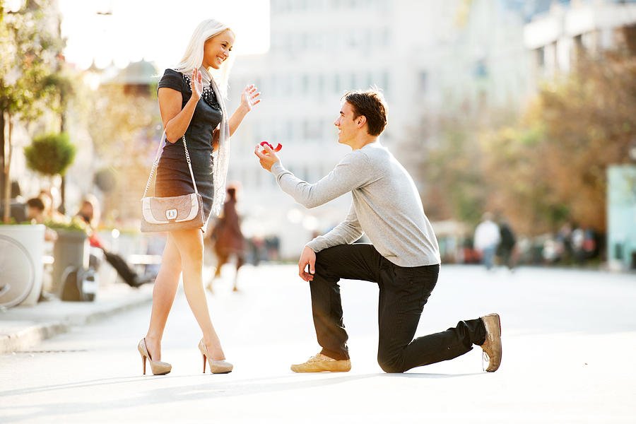 Young man proposing to a woman. Photograph by Skynesher