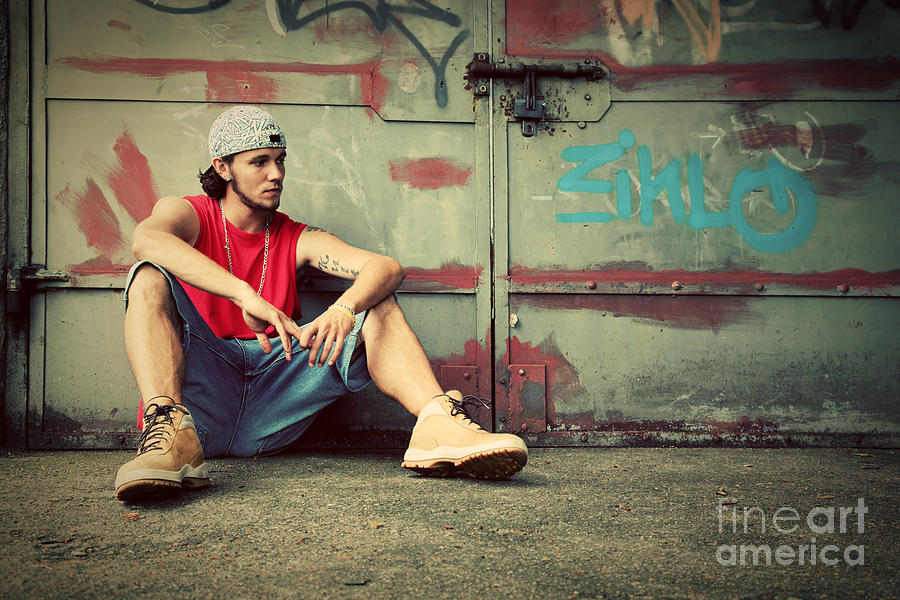 Cool Photograph - Young man sitting Grunge graffiti wall by Michal Bednarek