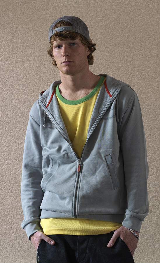 Young man standing with hands in pockets, portrait Photograph by Bob Thomas
