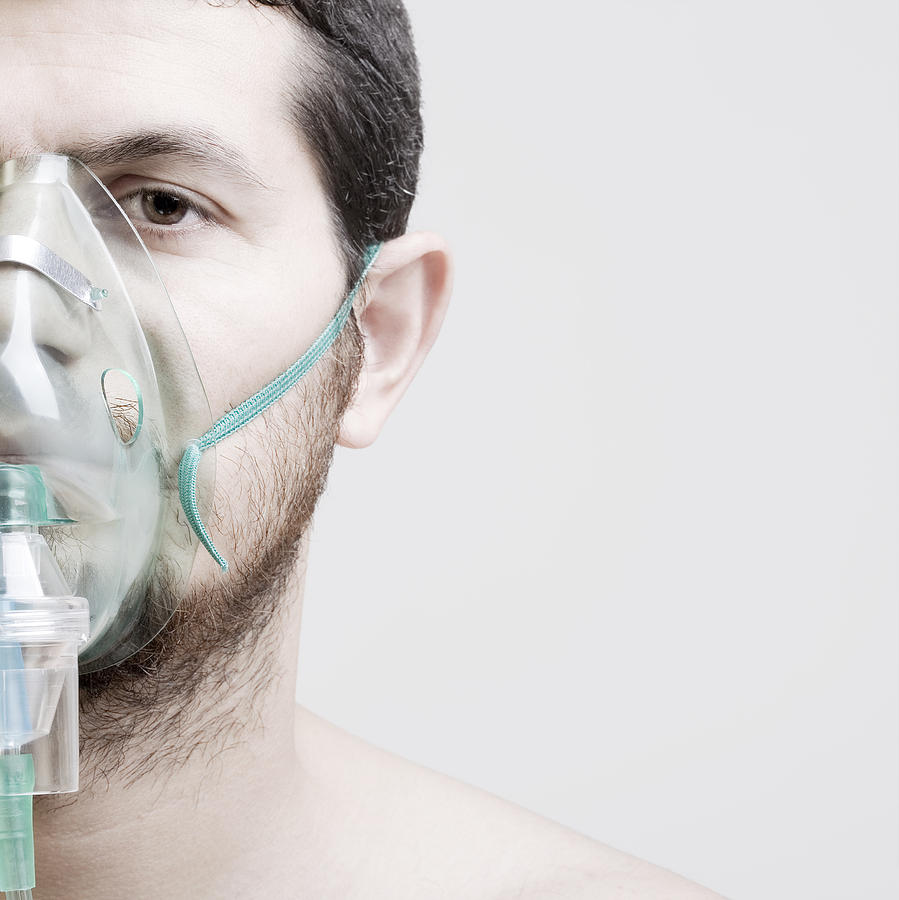 Young man with oxygen mask Photograph by Ozgurdonmaz