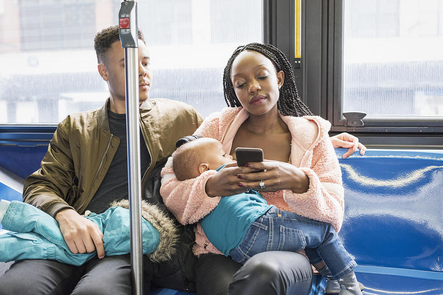 Young mother father and infant riding city bus Photograph by Tony Anderson