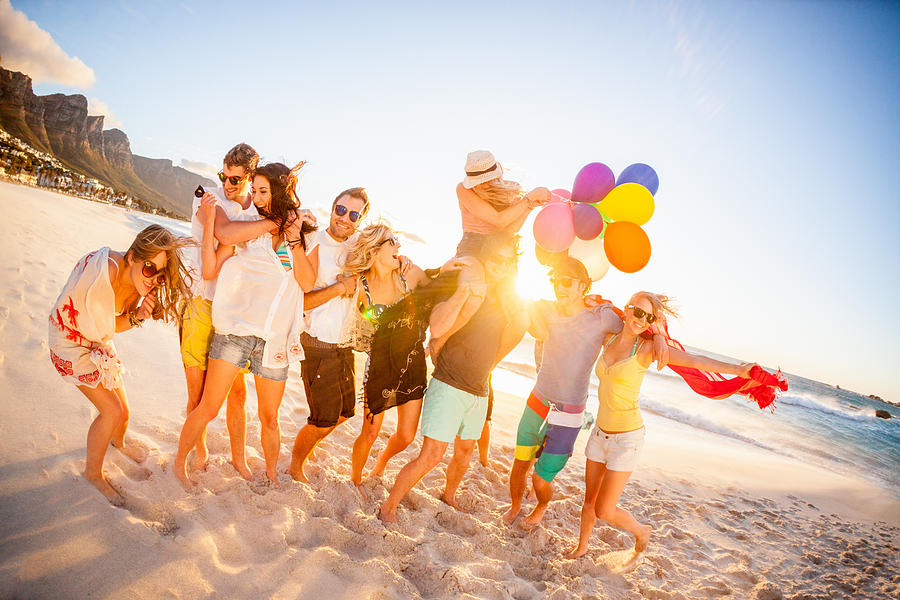 Young Party People having fun at the beach Photograph by Wundervisuals