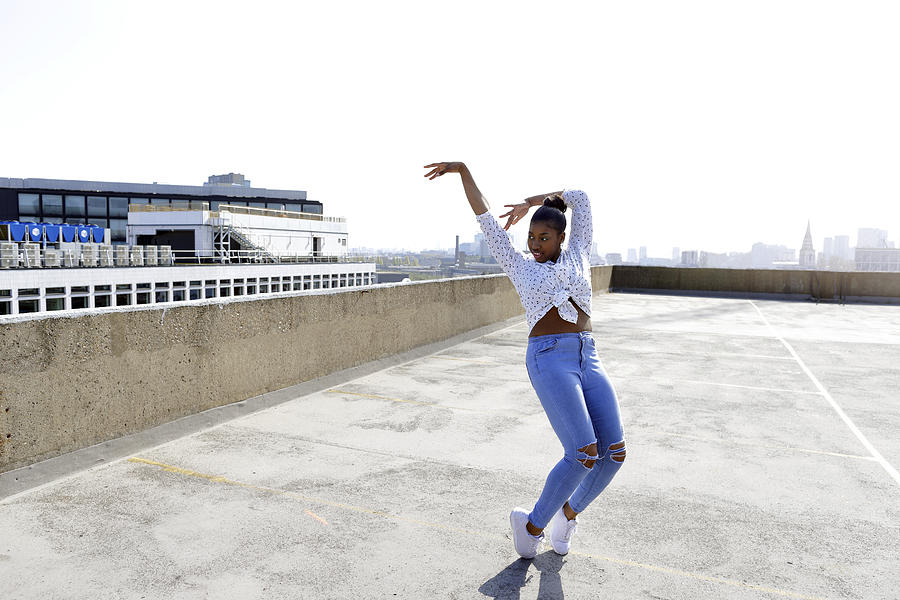 Young street dancers on London rooftop overlooking the city Photograph by Nick David