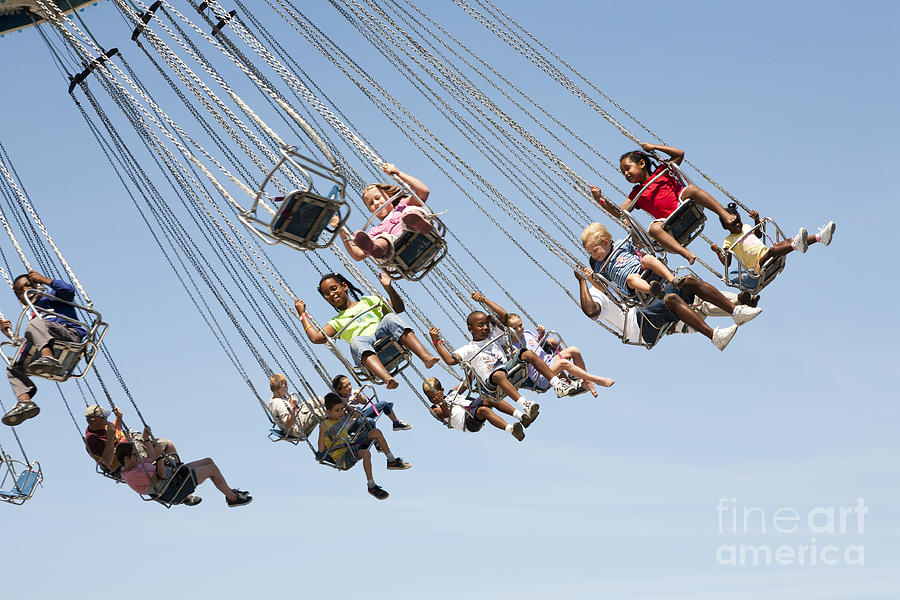 People on a Swing Carousel at a County Fair Photograph by William Kuta