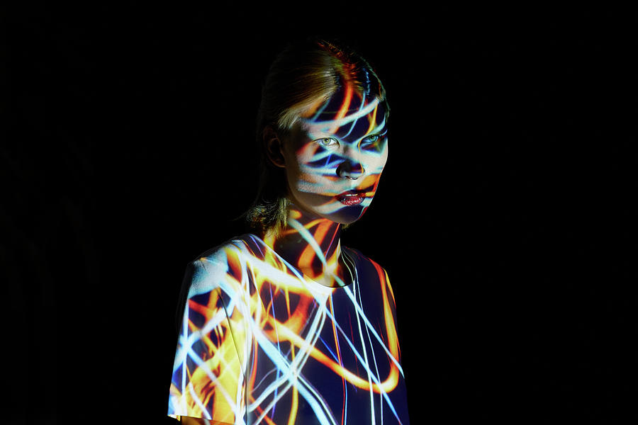 Young Woman Covered In Colorful Lights Photograph by Mads Perch