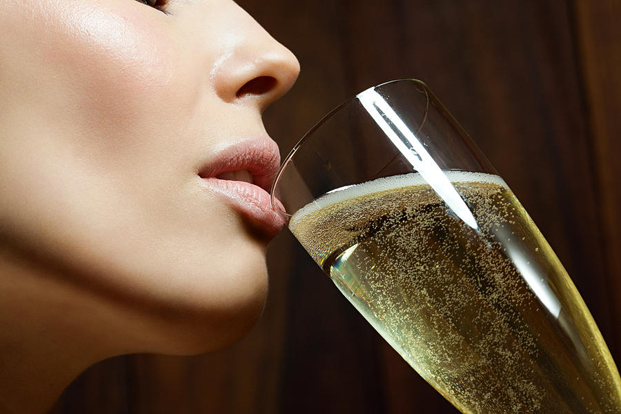 Young woman drinking champagne Photograph by Image Source