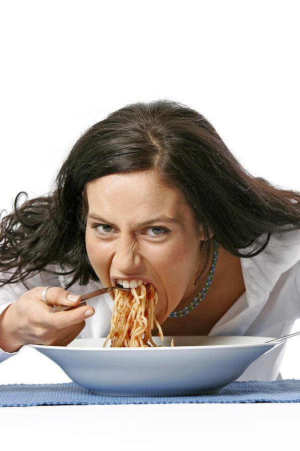Young woman eating spaghetti Photograph by Loop Delay