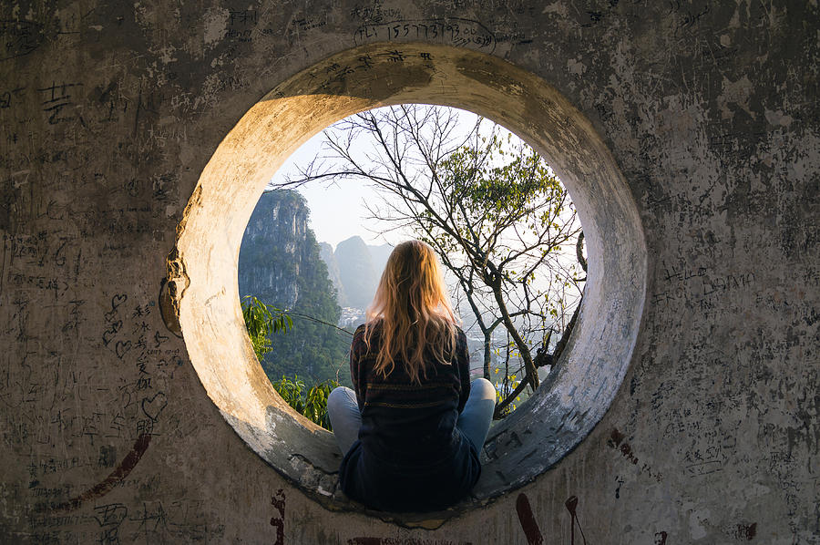Young woman enjoys view over Yangshuo, karst mountains Photograph by Andrii Lutsyk/ Ascent Xmedia