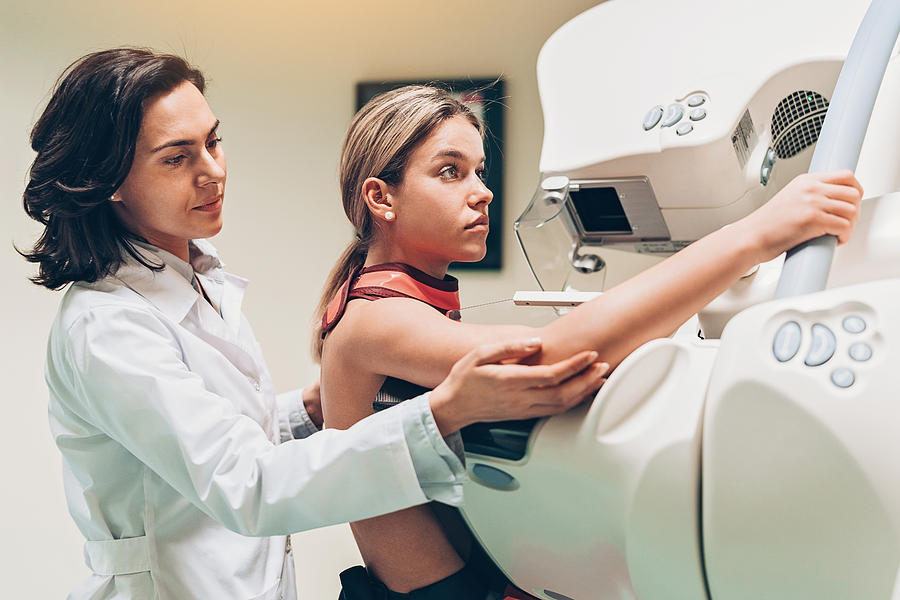 Young woman having a mammography Photograph by Pixelfit