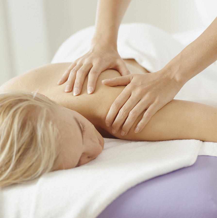 Young woman having massage, close-up Photograph by David De Lossy