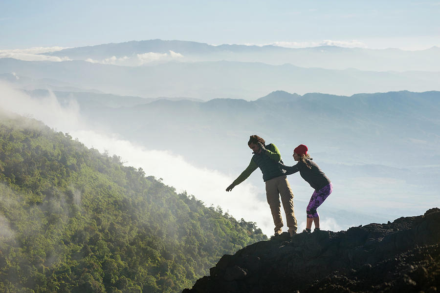 Young Woman Holding A Falling Man Photograph by Andres Valencia - Fine ...