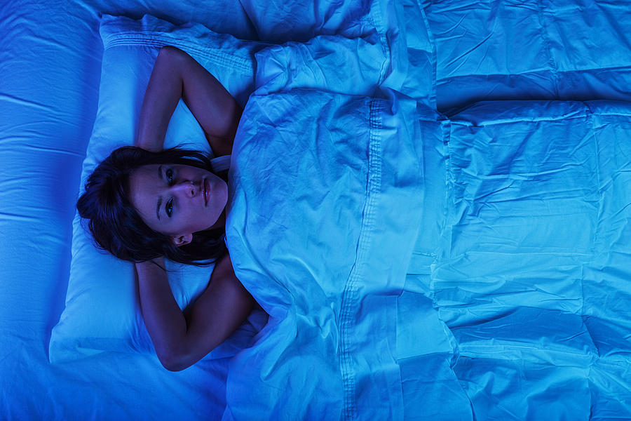 Young Woman in Bed with Insomnia Photograph by Jhorrocks