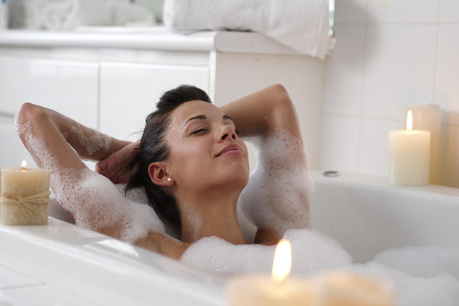 Young woman in bubble bath, smiling Photograph by Lwa