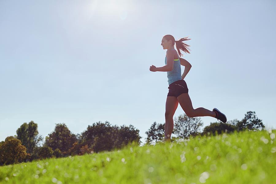 Young woman jogging - Stock Image - F020/7328 - Science Photo Library