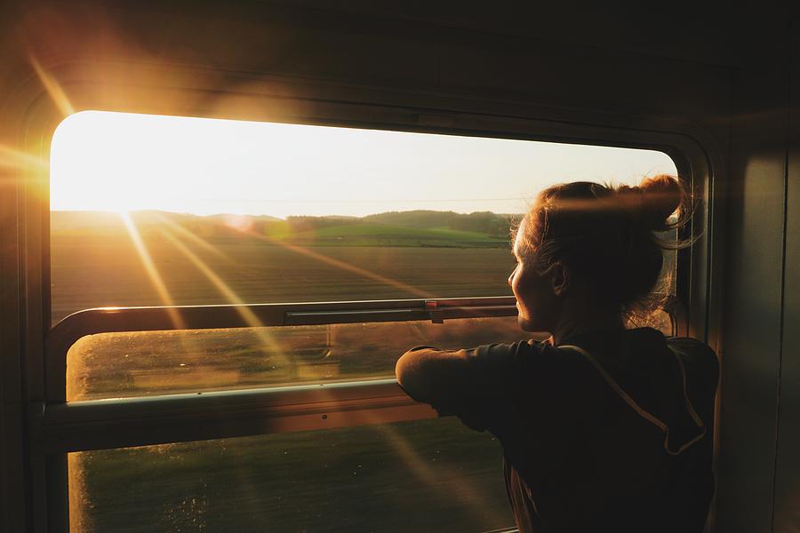 Young Woman Looking Through Window While Traveling In Train During Sunset Photograph by Pavel Schlemmer / EyeEm Young Woman Looking Through Window While Traveling In Train During Sunset Photograph by Pavel Schlemmer / EyeEm