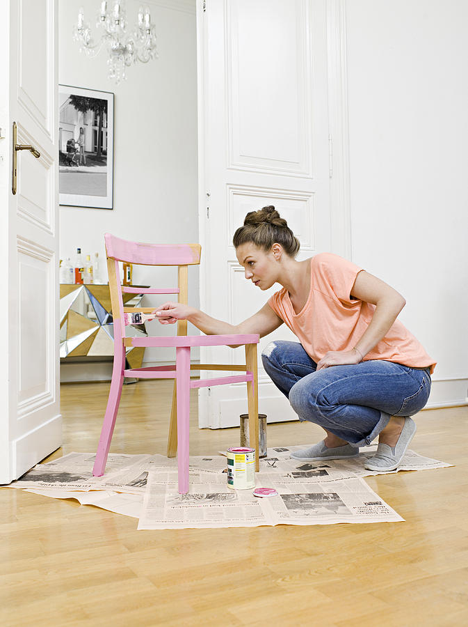 Young Woman Painting Wooden Chair Photograph by Joos Mind