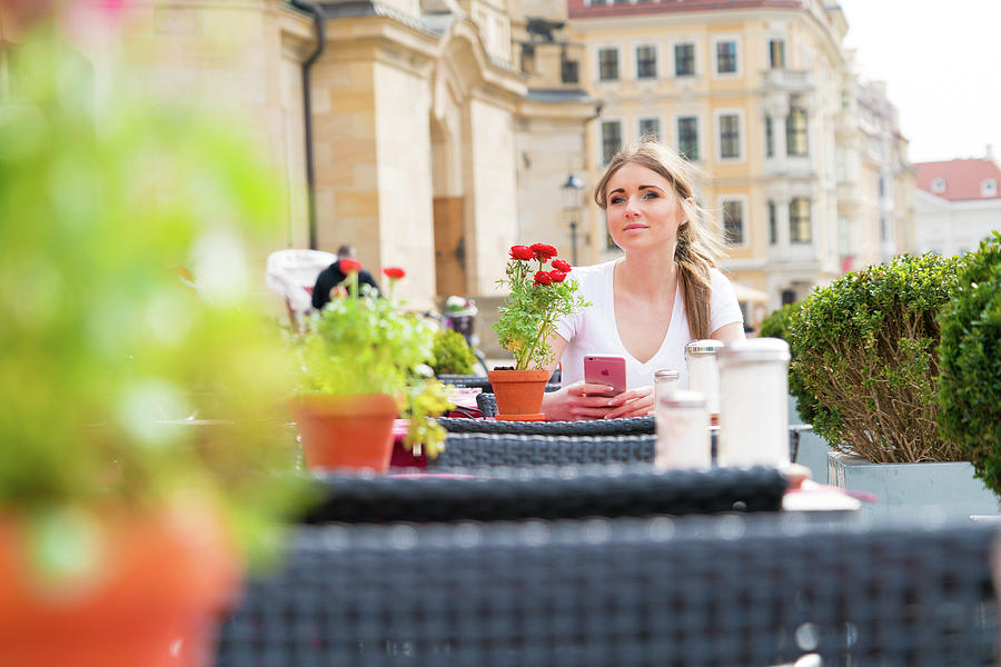 Young Woman Sitting At Outdoor Cafe Photograph by Science Photo Library Young Woman Sitting At Outdoor Cafe Photograph by Science Photo Library