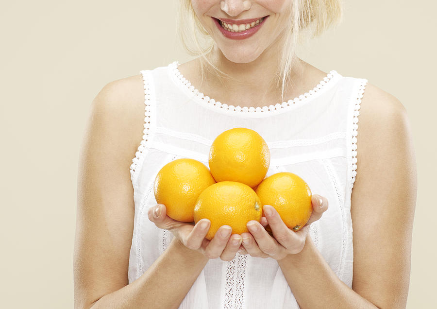 Young Woman Smiling And Holding Oranges Photograph by Oppenheim Bernhard