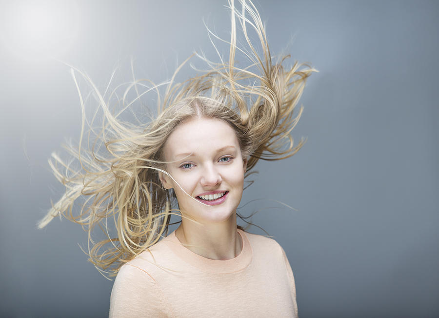 Young Woman Tossing Her  Flowing Long Hair Photograph by Betsie Van der Meer