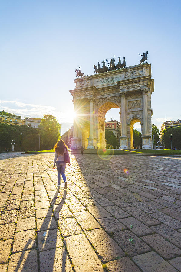 Young woman walking towards the Arch of Peace. Milan, Italy. Photograph by © Marco Bottigelli