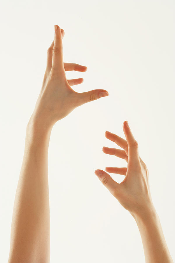 Young woman with hands in air, close-up Photograph by Marili Forastieri
