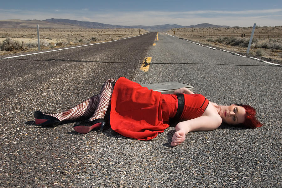 Young woman with is laying lifelessly  on highway Photograph by Alina555