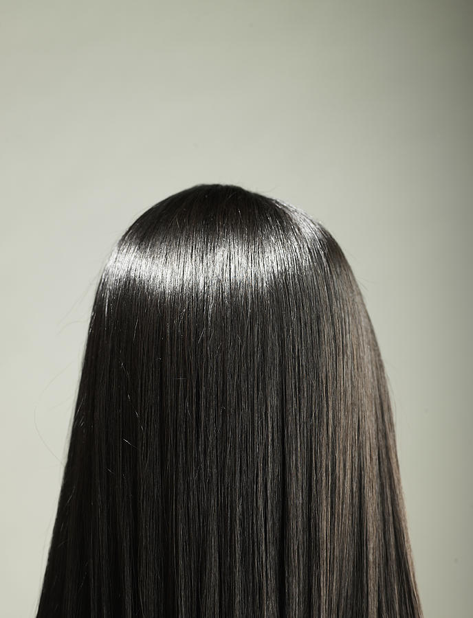 Young woman with long hair, rear view Photograph by Ryan McVay