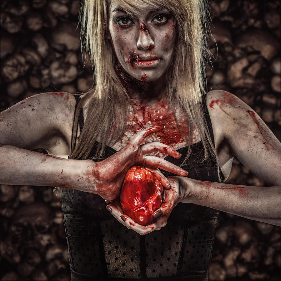 Young Zombie Woman Holding a Human Heart Photograph by Juhy13