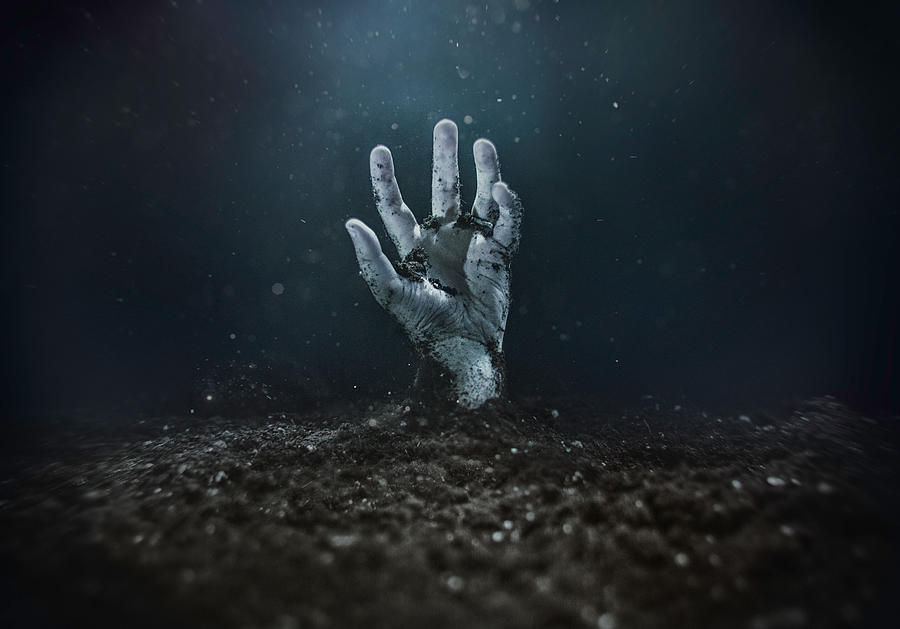 Zombie hand emerging from the ground Photograph by © Marc Mateos