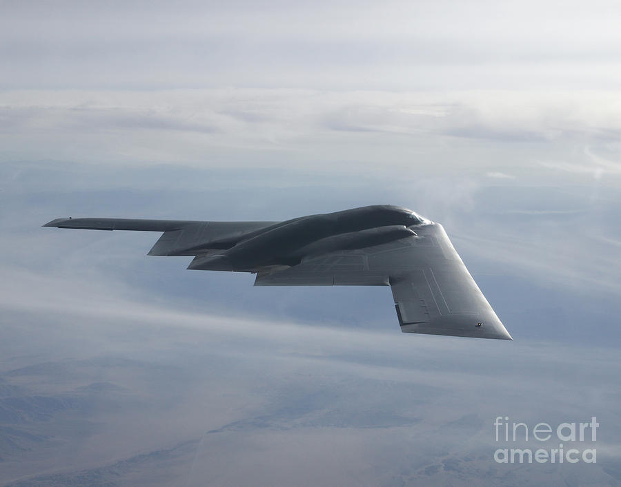 A B-2 Spirit Soars Through The Sky Photograph By Stocktrek Images ...