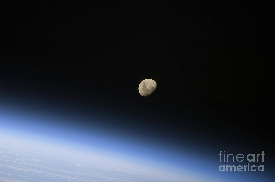 A Gibbous Moon Visible Above Earths Photograph