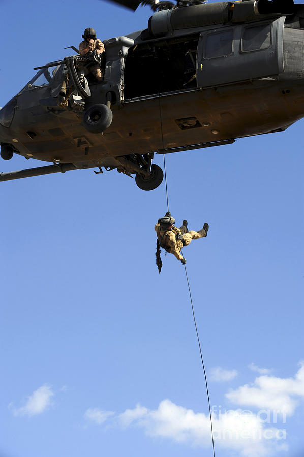 Rope Photograph - A Pararescueman Rappels From An Hh-60 #1 by Stocktrek Images
