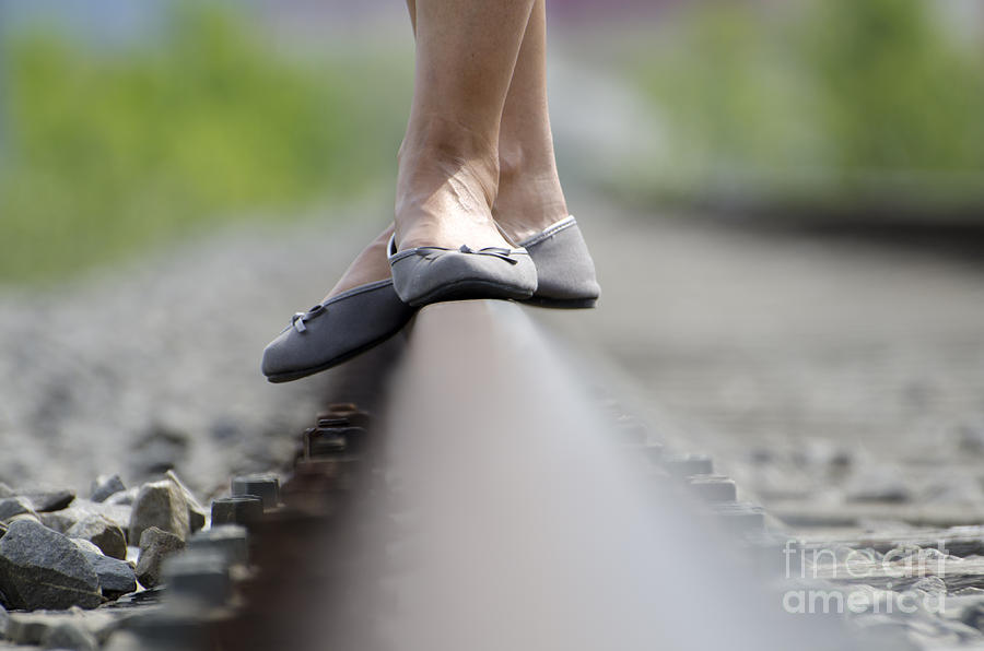 Balance on railroad tracks #1 Photograph by Mats Silvan