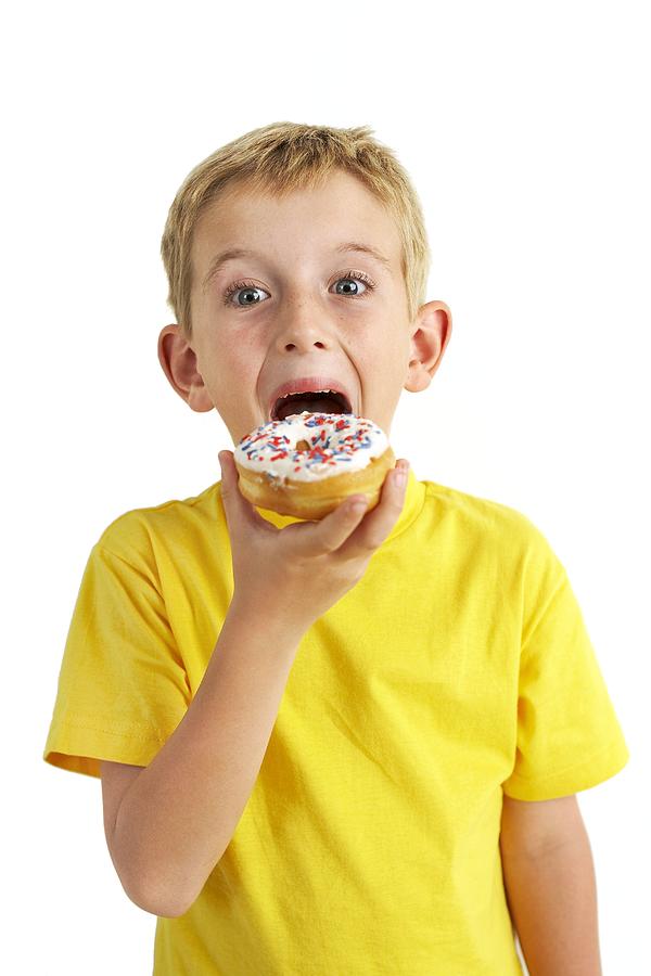 Donut Photograph - Boy Eating A Doughnut #1 by Ian Boddy
