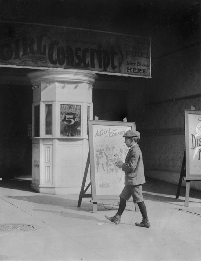 Boy In Front Of A Movie Theater Showing #1 Photograph by Everett Boy In Front Of A Movie Theater Showing #1 Photograph by Everett