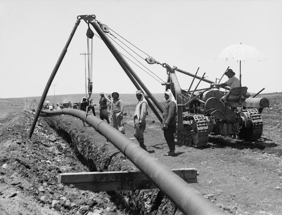 Dropping A Welded Pipe Into A Trench Photograph by Everett - Pixels