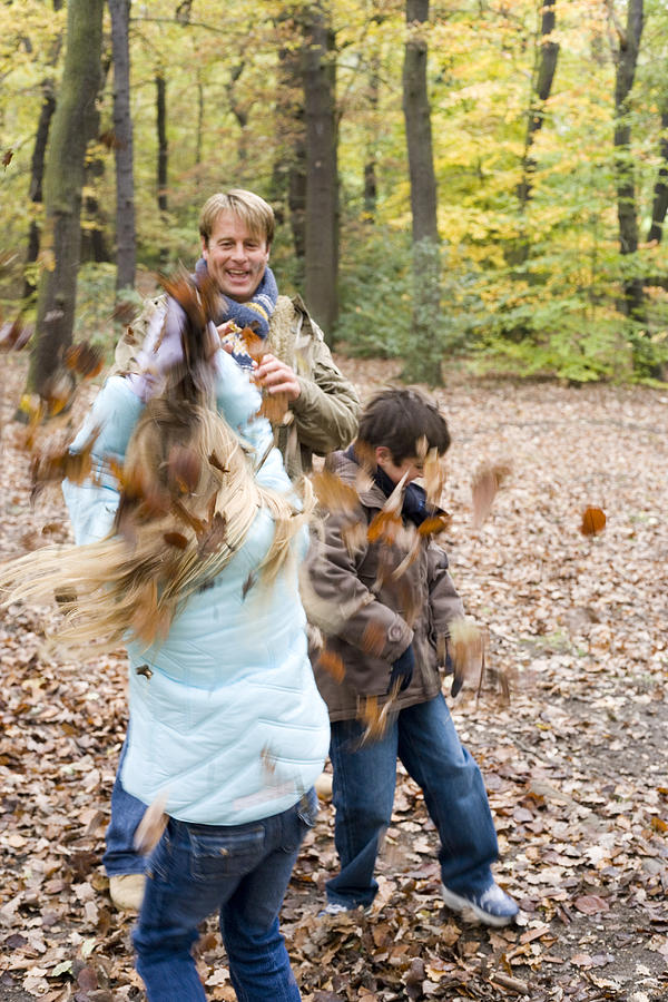 Fall Photograph - Father And Children Playing In A Wood #1 by Ian Boddy