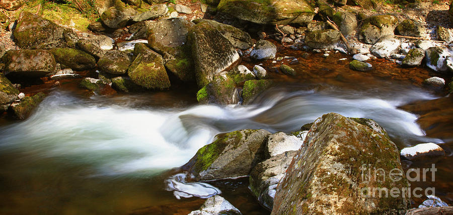 Flowing river blurred through rocks #1 Photograph by Simon Bratt