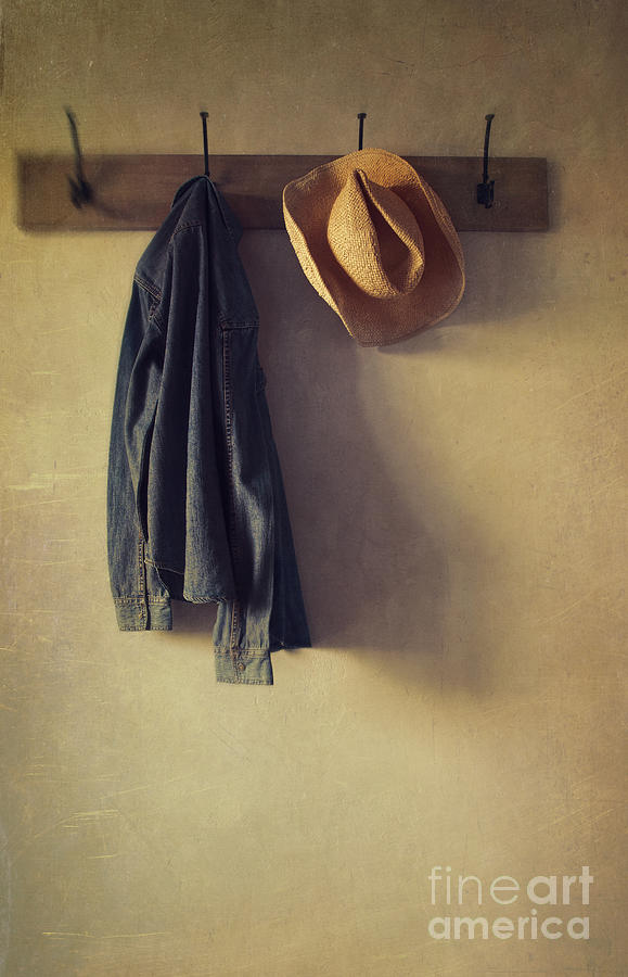 Jean shirt and straw hat hanging on hooks #1 Photograph by Sandra