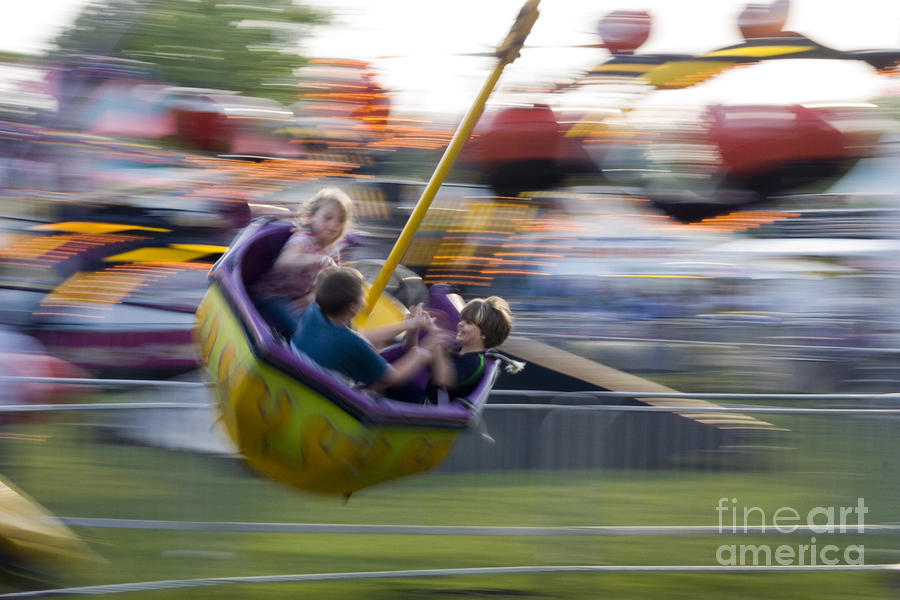 Kids Twirling Around On Amusement Ride Photograph by Christopher Purcell