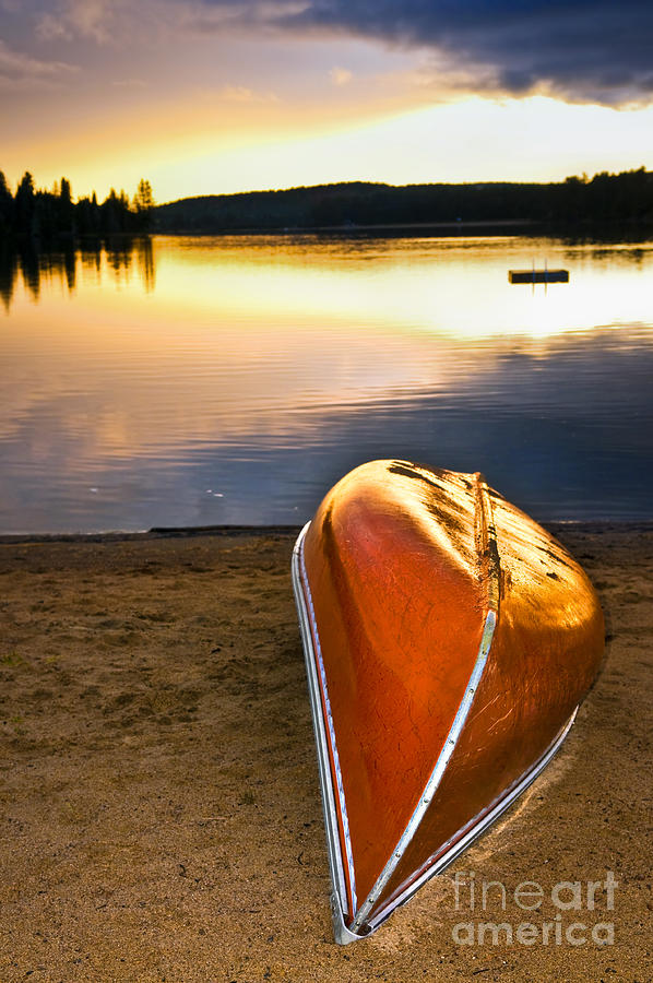 Lake sunset with canoe on beach 3 Photograph by Elena Elisseeva